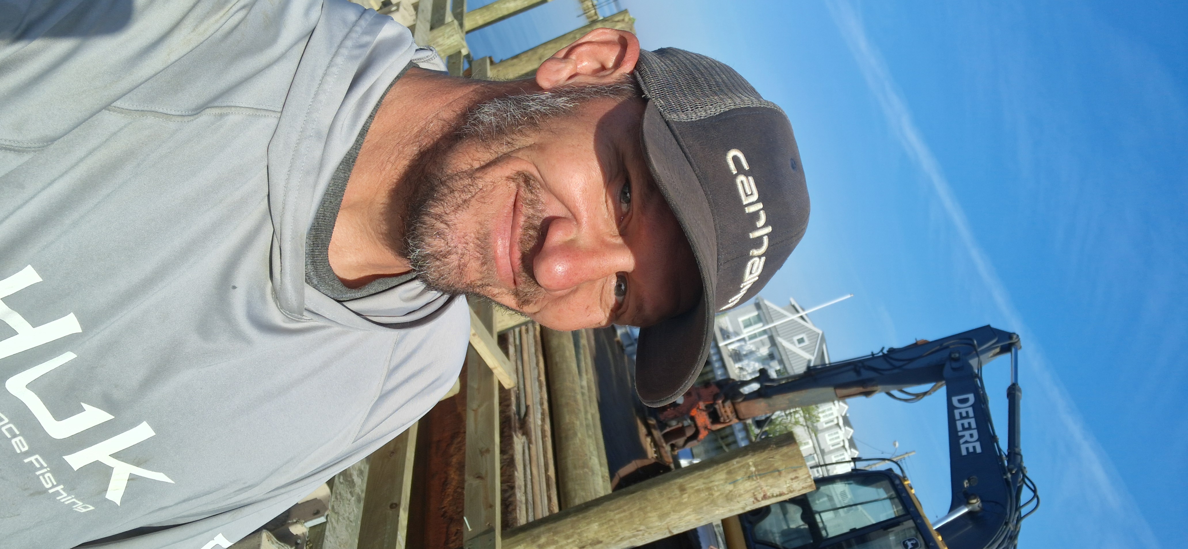 Operator POV from excavator cab during marine site work